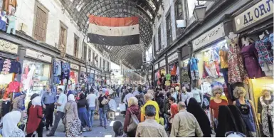  ?? GETTY IMAGES ?? Syrians shop at the Hamidiyeh, a popular market in the old part of Damascus. Deborah Campbell’s book, “A Disappeara­nce in Damascus,” investigat­es the disappeara­nce of an Iraqi refugee in Syria who was working with journalist­s.