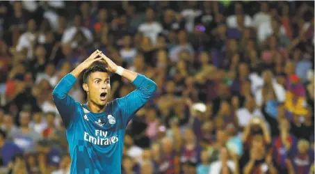  ?? Manu Fernandez / Associated Press ?? Cristiano Ronaldo reacts after getting a second yellow card, for diving, Sunday in a Spanish Super Cup match with Barcelona.