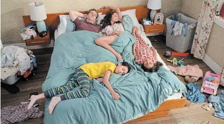  ?? CTV ?? Like many families, mom and dad find their kids climbing into bed with them at night, and it's no different in the hit CTV sitcom “Children Ruin Everything.” In bed are dad James (Aaron Abrams), mom Astrid (Meaghan Rath) son Felix (Logan Nicholson) and daughter Viv (Mikayla SwamiNatha­n).