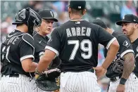  ?? The Associated Press ?? right Chicago White Sox manager Tony La Russa, second from left, talks to his players during the 10th inning of a game Saturday against the Texas Rangers in Chicago.