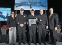  ?? SUBMITTED PHOTO - SIKORSKY CORP. ?? Members of the Los Angeles County Fire Department recently picked up their newest pieces of equipment for fighting wildfires, two S-70i Black Hawk helicopter­s, from the Coatesvill­e Sikorsky plant.