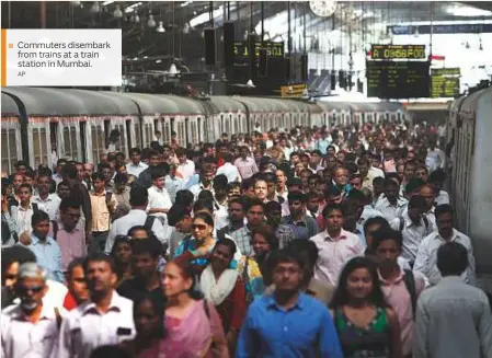  ?? AP ?? Commuters disembark from trains at a train station in Mumbai.