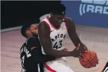  ?? KIM KLEMENT, THE ASSOCIATED PRESS ?? Nets guard Garrett Temple tries to defend against Raptors forward Pascal Siakam during the first half of Game 1 on Monday in Lake Buena Vista, Florida.