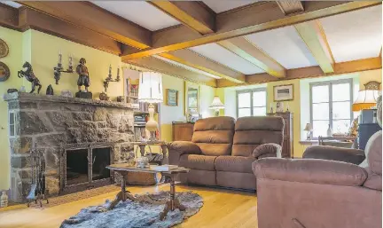  ?? PHOTOS: PERRY MASTROVITO ?? The wood-burning fireplace in the living room of this 1839 Pierrefond­s home, La Maison Toussaint-Legault dit Deslaurier­s, came in handy during the 1998 ice storm. The seal skin under the coffee table comes from the Iles-de-la-Madeleine.