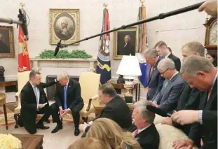  ??  ?? Trump and Brunson participat­e in a prayer at the Oval Office. Also seen are members of Congress and administra­tion officials.