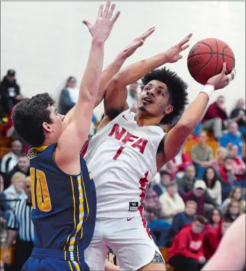  ?? SEAN D. ELLIOT/THE DAY ?? NFA’s Xavier Marquez (1) puts up a shot over Woodstock Academy’s Cole Hackett (10) during the third-seeded Wildcats’ 63-42 win over the No. 7 Centaurs in Saturday’s ECC Division I tournament semifinal at Waterford.