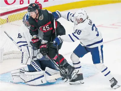  ?? ADRIAN WYLD THE CANADIAN PRESS ?? Leafs goalie Jack Campbell holds his ground after Rasmus Sandin cross-checks the Senators’ Parker Kelly in the crease Thursday.