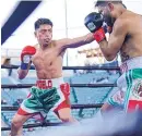  ?? COURTESY OF ANGELO LEO ?? Angelo Leo, left, lands a jab against Alberto Torres during a fight in February. Leo fights for a world title on Saturday night.