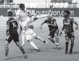  ?? MATIAS J. OCNER mocner@miamiheral­d.com ?? Inter Miami defender Nicolas Figal fights for possession against three Galaxy players in the first half of Sunday’s season-opening game at DVR PNK Stadium in Fort Lauderdale.