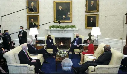  ?? ASSOCIATED PRESS ?? President Joe Biden, accompanie­d by Vice President Kamala Harris, speaks Friday with House Speaker Nancy Pelosi and House Majority Whip James Clyburn (right) House Majority Leader Steny Hoyer (seated second left) and Rep. Peter DeFazio, D-Ore., (seated left) and Rep. John Yarmuth, D-Ky. (foreground), in the Oval Office of the White House in Washington.