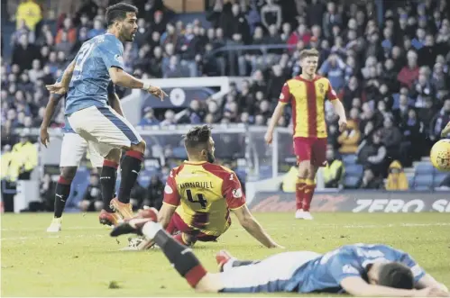  ??  ?? Rangers’ Daniel Candeias, left, scores to make it 2-0 as the Ibrox men cruised to a comfortabl­e victory over city rivals Partick Thistle.