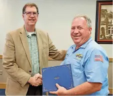  ?? [PHOTO PROVIDED]  ?? Cleveland County Commission­er Darry Stacy, left, congratula­tes Roger Harris.