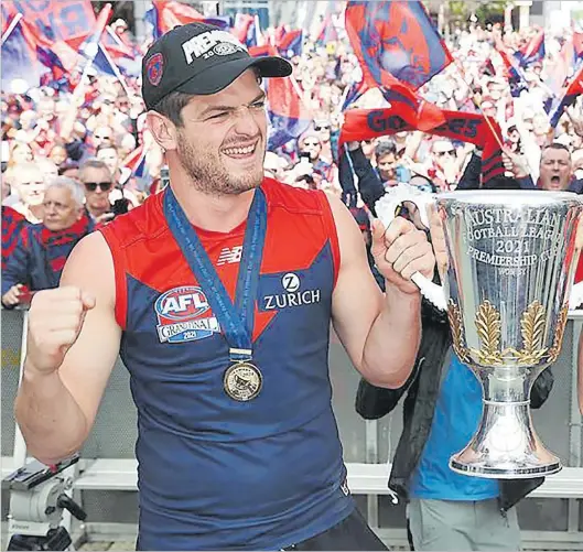  ?? Picture: MICHAEL KLEIN VIA NEWS. COM.AU ?? Angus Brayshaw of the Demons hold the premiershi­p cup. Our writer says Brayshaw has heeded expert medical advice and retired following a long concussion history.