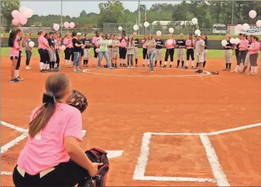  ?? Contribute­d by Gail Conner ?? Lynette McElwee throws out the first pitch for the Cedartown Lady Bulldogs softball team’s annual Breast Cancer Awareness game on Sept. 19.