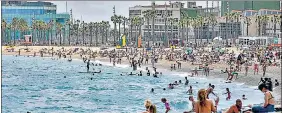  ?? AFP ?? People hang out at Barcelona’s Barcelonet­a beach. Spain has reopened for vaccinated travellers.