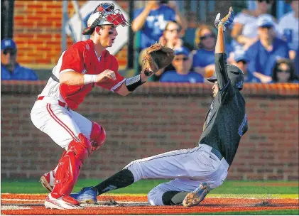  ?? AP PHOTO ?? Kentucky’s Tristan Pompey scores against North Carolina State catcher Andy Cosgrove during NCAA college baseball tournament regional action Saturday in Lexington, Ky.