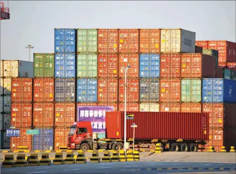  ??  ?? A truck transports a shipping container at Qingdao port in Shandong province. China’s exports to the US rose to $46.7bn while imports slumped to $12.6bn in September.