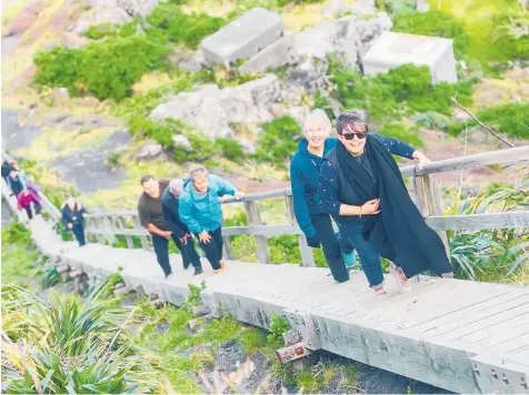  ?? Photo / Supplied ?? Robin Corbett (front), leads a group up to the Cape Palliser lighthouse.