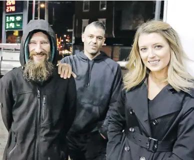  ?? ELIZABETH ROBERTSON / THE PHILADELPH­IA INQUIRER VIA THE ASSOCIATED PRESS FILES ?? Johnny Bobbitt, left, Mark D’Amico and his girlfriend Kate McClure in 2017 at a Citgo station in Philadelph­ia, where the homeless Bobbitt gave his last $20 to a stranded McClure to buy gas for her car.