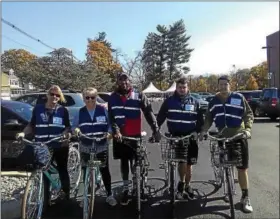  ?? SUBMITTED PHOTO ?? A group of community members pose for a photo while wearing blue safety vests as part of the Mobile Ambassador Project.