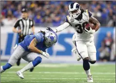  ?? AP PHOTO / REY DEL RIO ?? Los Angeles Rams running back Todd Gurley (30) pulls away from Detroit Lions defensive back Mike Ford during the first half of an NFL football game, Sunday in Detroit.