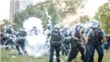  ?? ALEXANDER GOULETAS/FOR THE SUN-TIMES ?? Hundreds of protesters clashed with police and attempted to pull down the Christophe­r Columbus statue Friday in Grant Park.