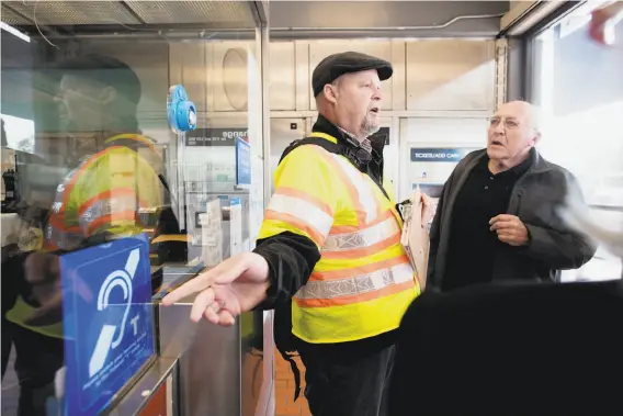  ?? Photos by Noah Berger / Special to The Chronicle ?? BART’s Carl Orman (left) explains the hearing-loop system installed at the Fremont Station to Walt Bateman, who was among those testing the system.