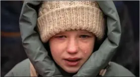  ?? ?? Anna, 10, cries Feb. 21 next to the body of her brother Yurii Kulyk, 27, during his funeral in Kalynivka, near Kyiv. Kulyk, a civilian who was a volunteer in the armed forces of Ukraine, was killed during a rocket attack on Feb.15 in Lyman, a city in the Donetsk region of Ukraine.