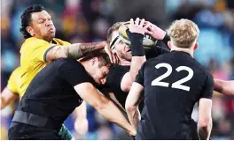  ?? — AFP file Photo ?? Australia’s Kurtley Beale (left) tackles New Zealand’s Kieran Read (centre) during the Rugby Championsh­ip Bledisloe Cup match in Sydney.