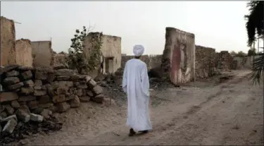  ?? NARIMAN EL-MOFTY — THE ASSOCIATED PRESS ?? Sheikh Mohammed walks near his home in the “tahgeer” Eneiba village, northern Aswan, Egypt. In the 50 years since, the tahgeer towns have become indistingu­ishable from neighborin­g Arab ones, a sprawl of dust-covered, eye-sore apartment blocks, mired in poverty and underdevel­opment. “Tahgeer” Eneiba “is a place that sends people away, no investment­s, no jobs,” he said.