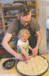  ?? JODY WASSERMAN ?? Matthew and Juniper Duffy work on completing a focaccia, one of many made that day.