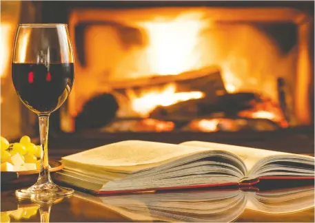  ?? ISTOCK/GETTY IMAGES PLUS ?? A glass of vino, a soothing fire and a good book — we can think of worse ways to spend Valentine's Day during a pandemic.