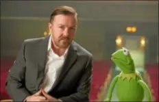  ??  ?? Disney shows Ricky Gervais, left, as Dominic and Kermit the Frog as Constantin­e, right, from Disney’s “Muppets Most Wanted.” Disney is previewing several of the studio’s upcoming live-action films for fans at the D23 Expo, this weekend, a three-ay...