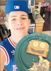 ??  ?? Christian Sechel of Tinley Park High School shows off some healthy and happy toast he learned to make in a virtual physical education class.