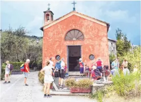  ??  ?? Hikers take a rest at the San Sebastiano Church.