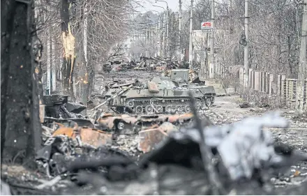  ?? AFP ?? Destroyed Russian armoured vehicles line the street in the city of Bucha, west of Kyiv on March 4, 2022. On that day, the UN Human Rights Council overwhelmi­ngly voted to create a top-level investigat­ion into violations committed following Russia’s invasion of Ukraine.
