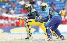  ?? FILE ?? Andre McCarthy of Jamaica Tallawahs plays a sweep shot, while Nicholas Pooran of the Barbados Tridents watches the ball during Match 5 of the 2017 CPL between Jamaica Tallawahs and Barbados Tridents at Central Broward Regional Park Stadium in Fort...