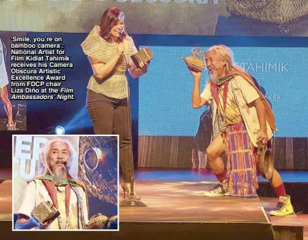  ??  ?? ‘Smile, you’re on bamboo camera’: National Artist for Film Kidlat Tahimik receives his Camera Obscura Artistic Excellence Award from FDCP chair Liza Diño at the Film Ambassador­s’ Night.