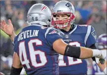  ?? ELISE AMENDOLA/AP PHOTO ?? New England Patriots quarterbac­k Tom Brady, right, celebrates a touchdown run by James Develin during the second half of Sunday’s game gainst the Minnesota Vikings at Foxborough, Mass.