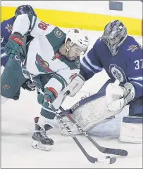  ?? CP PHOTO ?? Minnesota Wild’s Jordan Greenway can’t get the puck past Winnipeg Jets goaltender Connor Hellebuyck during NHL playoff action Friday in Winnipeg.
