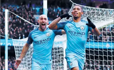  ?? CAIRNDUFF / REUTERS ?? Gabriel Jesus (right) celebrates scoring Manchester City’s second goal with Pablo Zabaleta during their 2-1 English Premier League victory over Swansea at Etihad Stadium on Sunday.