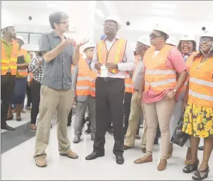  ?? (Terrence Thompson photo) ?? An engineer explains the ongoing works in the departure terminal to the ministers.