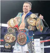  ??  ?? Gennady Golovkin poses with his belts after defeating Vanes Martirosya­n last month.