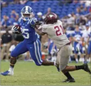  ?? BEN MCKEOWN - THE ASSOCIATED PRESS ?? Duke’s Deon Jackson (25) shoves away North Carolina Central’s Daryl Smith (21)during the second half of an NCAA college football game in Durham, N.C., Saturday, Sept. 22, 2018. Duke defeated North Carolina Central 55-13.