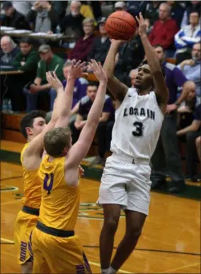  ?? RANDY MEYERS — FOR THE MORNING JOURNAL ?? Lorain’s Devon Grant scores over Niko Pappas and Cole Warren of Avon during the second quarter of a Division I district semifinal on March 6.