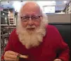  ?? LIGAYA FIGUERAS/LFIGUERAS@AJC.COM ?? Santa Phil eats a chicken wing.