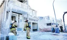 ?? RYAN MCLEOD ?? Firefighte­rs enter a home affected by a blaze in Cityscape on Wednesday. One home was destroyed in the fire.