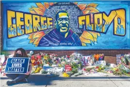  ?? Picture: AFP ?? TRIBUTE. Flowers, signs and balloons are left at a makeshift memorial near the spot where George Floyd died.