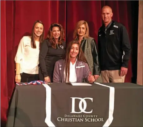  ?? COURTESY DELAWARE COUNTY CHRISTIAN SCHOOL ?? Senior Elene Tsokilauri, fresh off winning the PIAA Class AA singles crown Saturday, signs her national letter of intent for Boston College in a ceremony Wednesday at Delco Christian. Standing behind Tsokilauri are, from left, Delco Christian head...