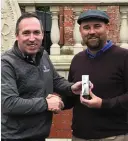  ??  ?? Portmarnoc­k Links’ PGA pro Conor Russell presents Gary Murphy with his prize at the TaylorMade Winter Alliance outing on Tuesday